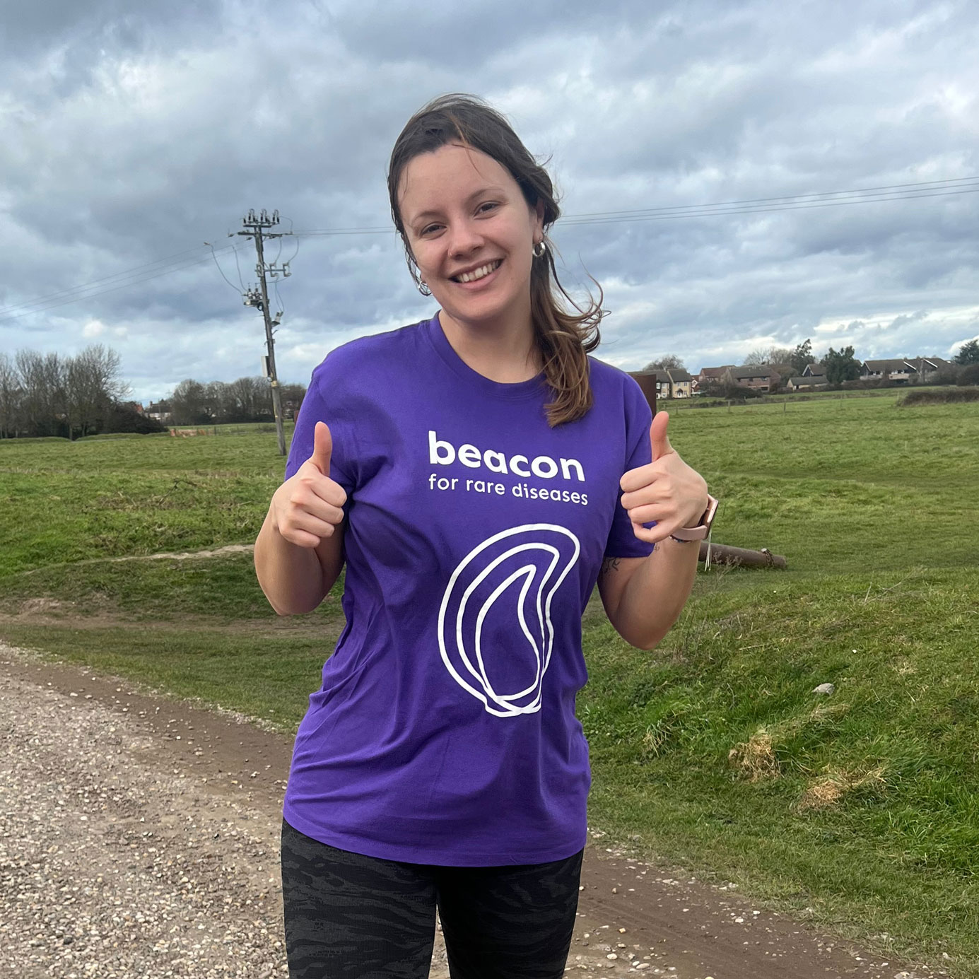 Photo of a woman training for a fundraising run wearing a Beacon t-shirt