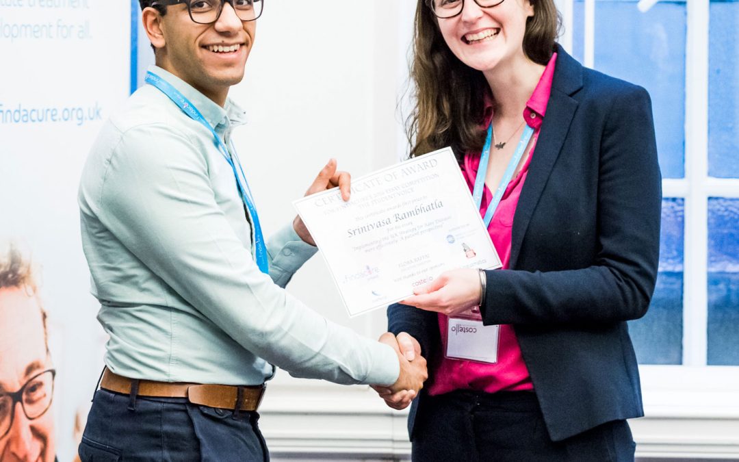 Photo of a student being awarded their certificate for the student voice prize essay competition