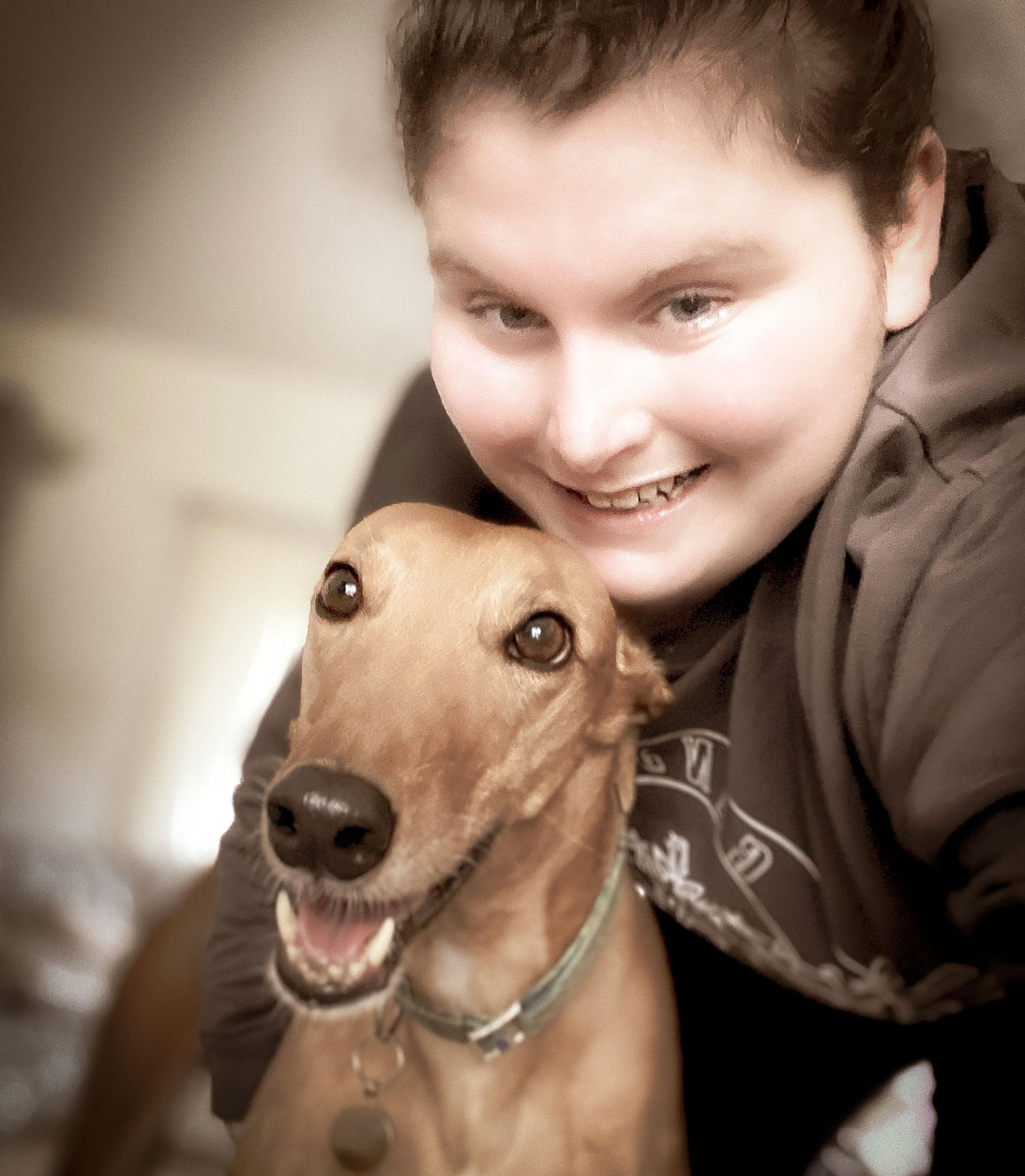 Photo of Cailin smiling with her dog Penny