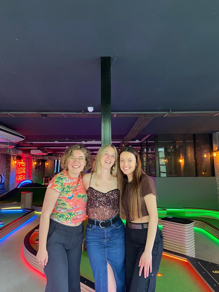Photo of Phil, Hannah and Faith at mini golf.