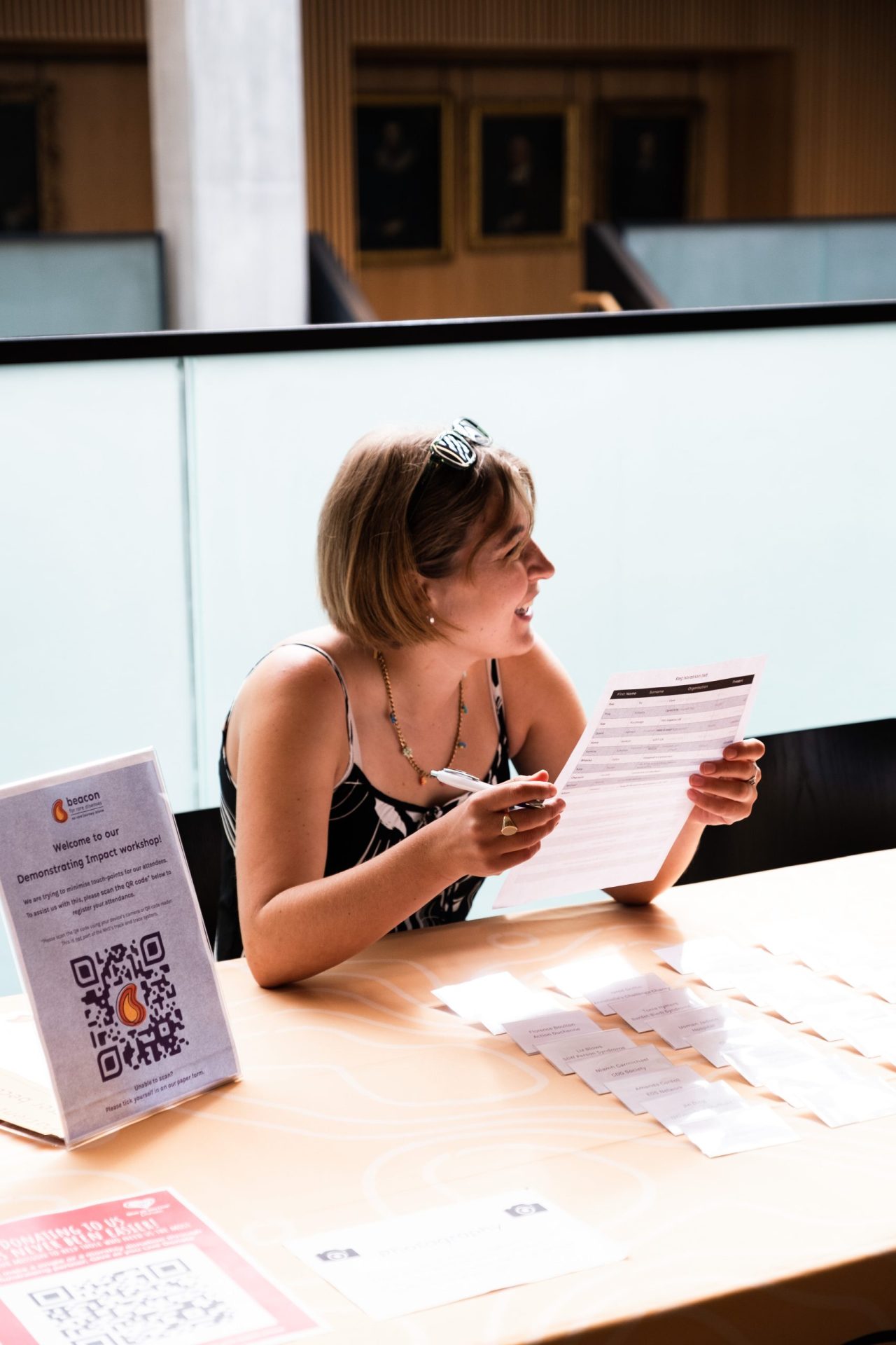 Photo of Phil smiling at a registration desk at a Beacon event.