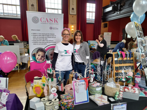 Photo of two ladies standing at a CASK exhibition booth at a Christmas fair