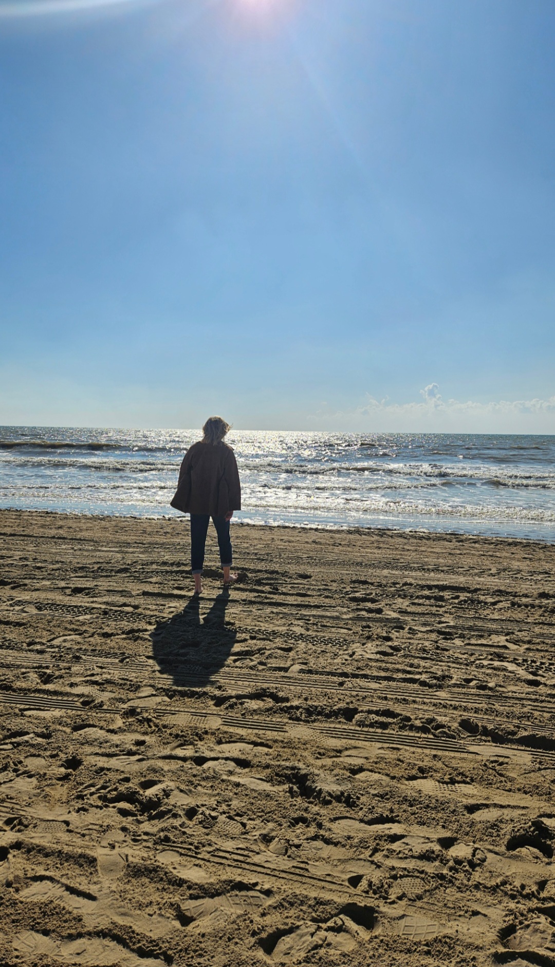 Photo of Maddie and friend by the sea.
