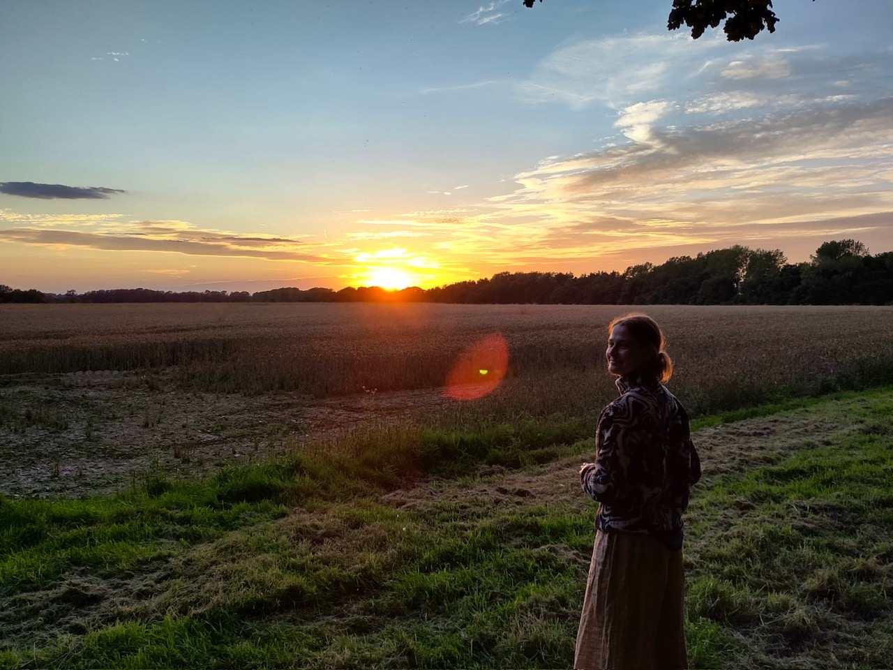 photo of Maddie in front of a sunset
