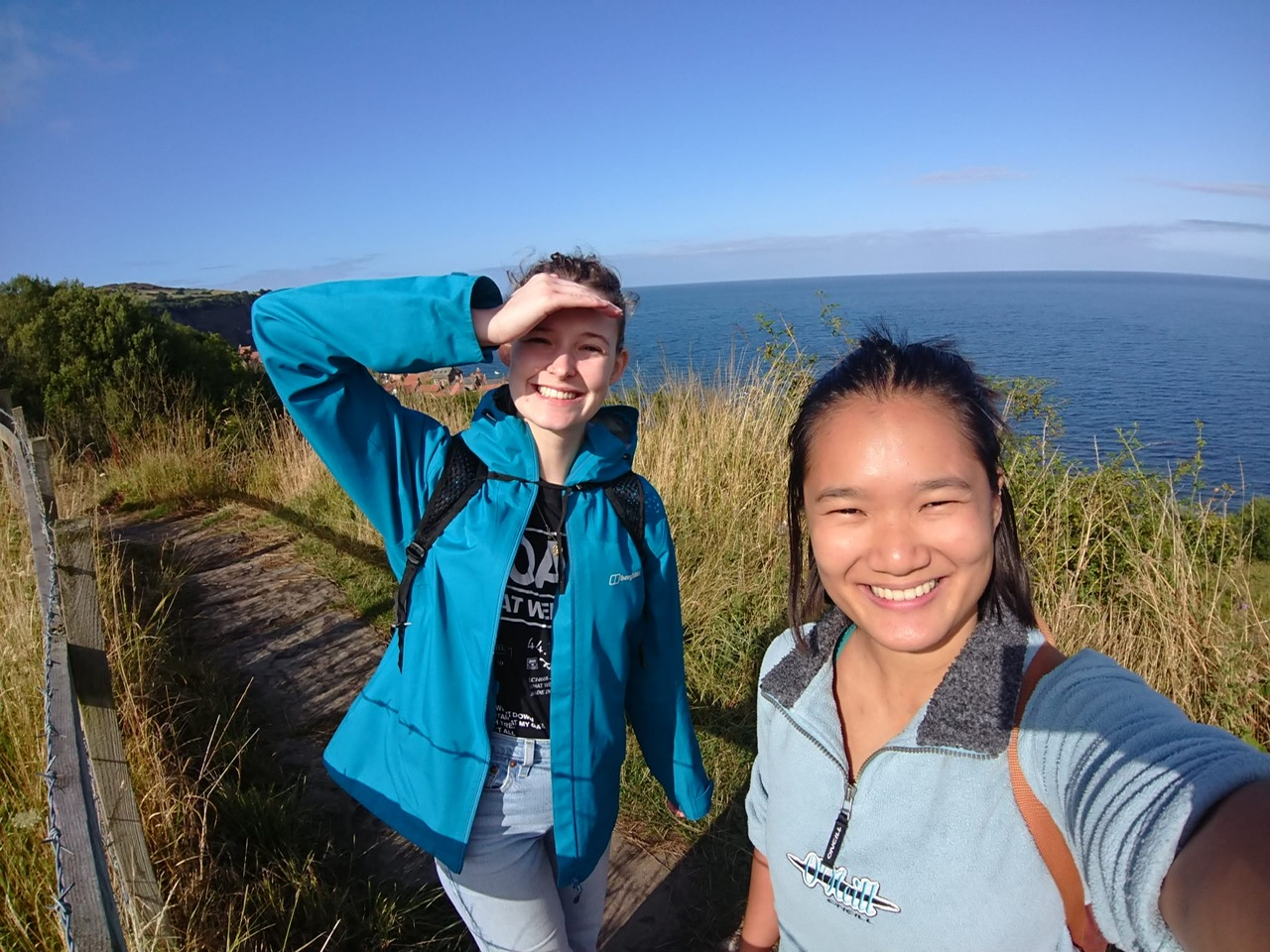 Photo of Maddie and friend by the sea.