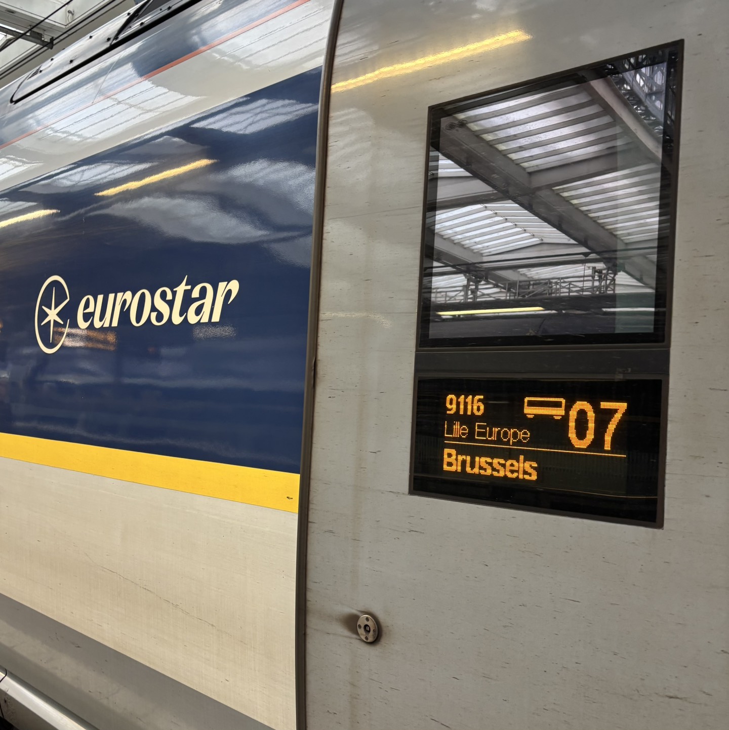 Eurostar train on the platform. Text reads 'Brussels'