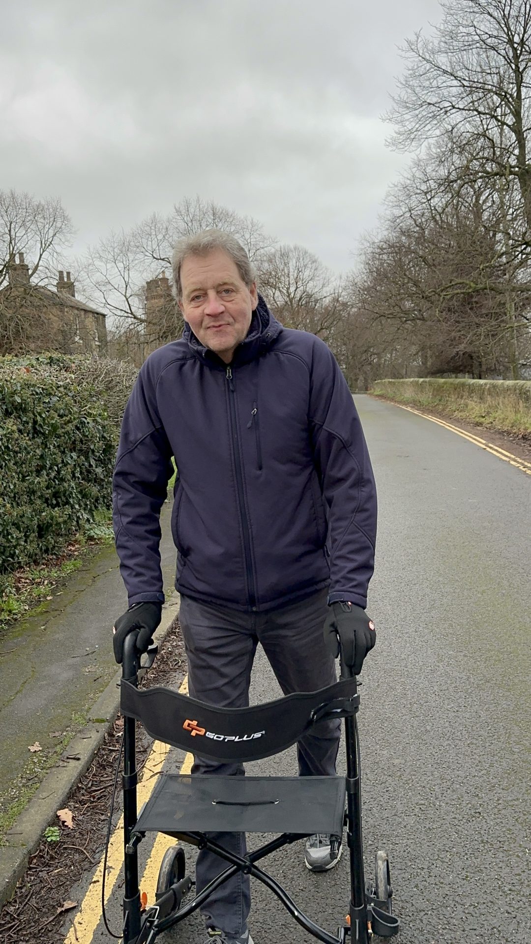 Image of Ian walking with a walking frame