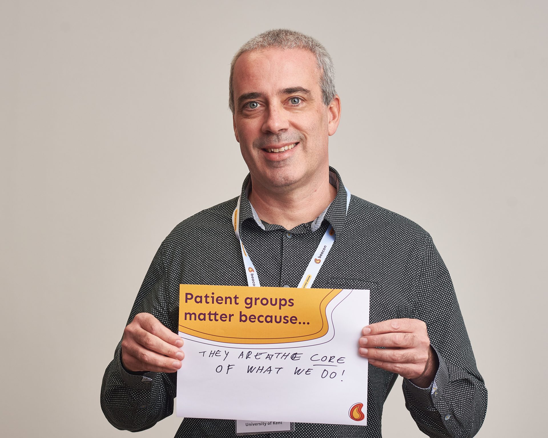 Man holding a sign saying 'patient groups matter'