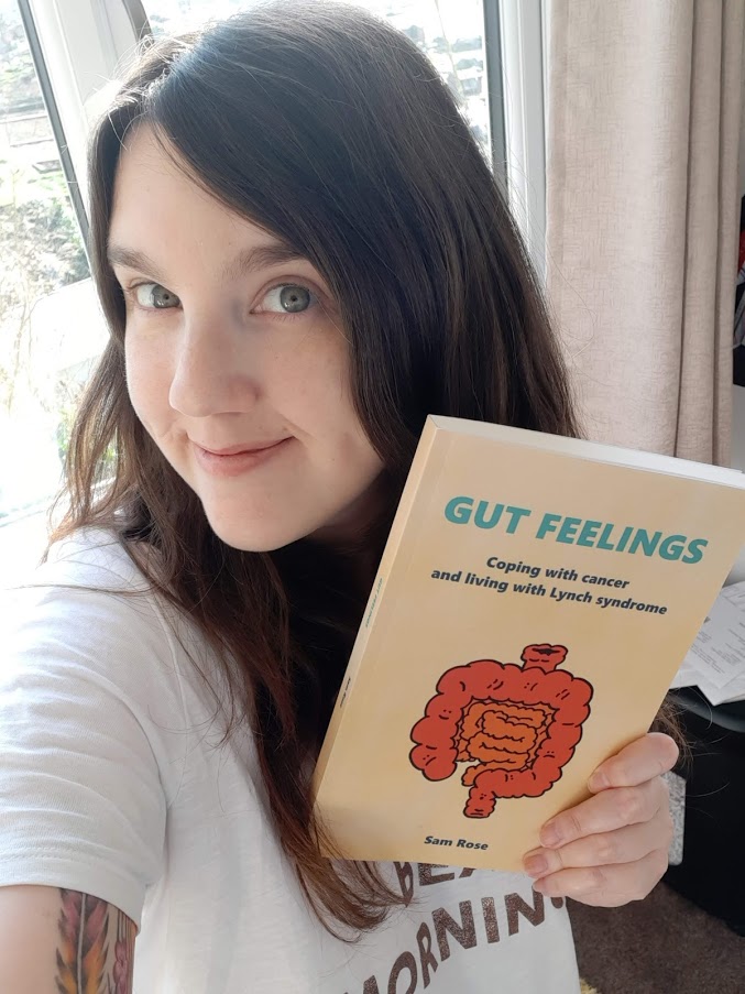 Sam holding their poetry book